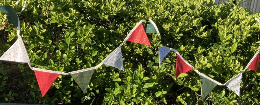 A variety of red, green & cream flags. 3m in length including 30cm each end to tie. $20 each